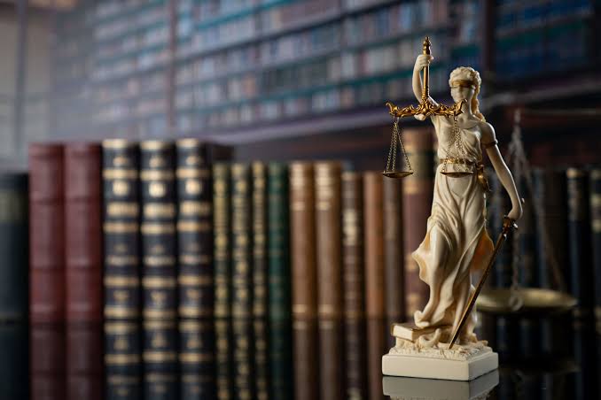 Lady Justice statue and law books